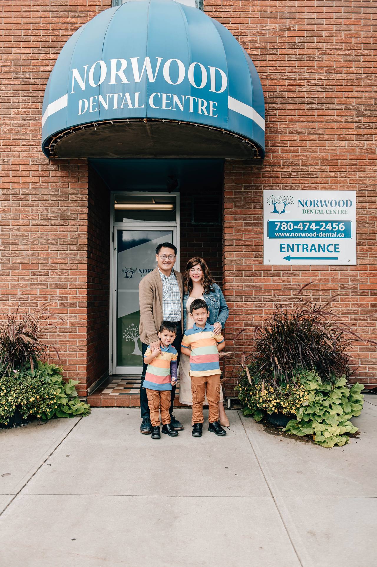 The Chin family at the entrance of Norwood Dental Centre on Alberta Avenue