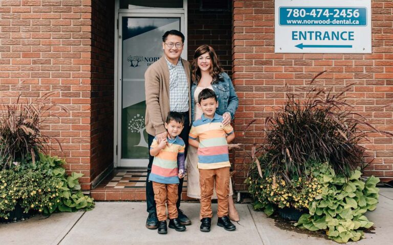 The Chin family at the Norwood Dental Centre entrance on 95 Street