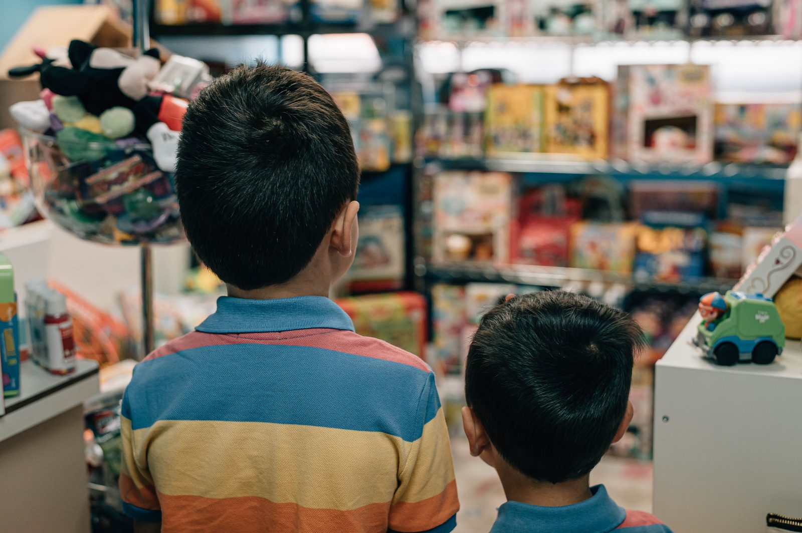Two children looking at the Norwood Dental Centre toy room shelves
