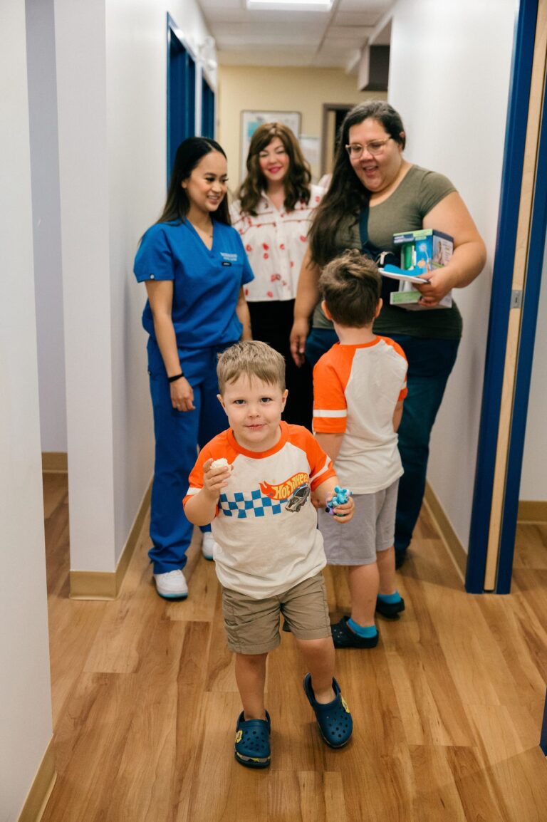 Kids leaving the Inglewood clinic open house with goody bags and treats