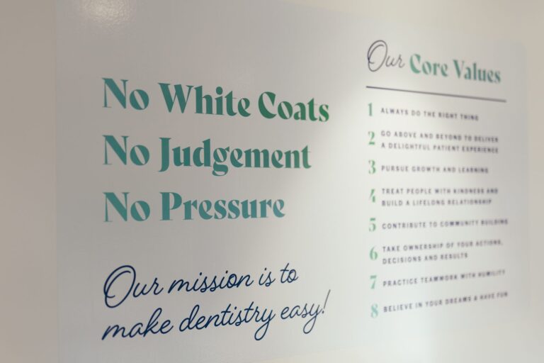 The No White Coats, No Judgement, No Pressure brand wall with the core values list