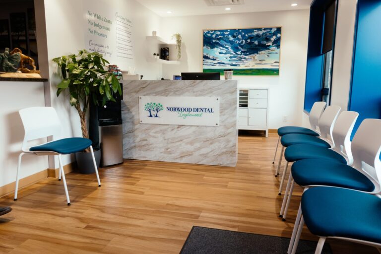 The Inglewood waiting area with blue chairs and Norwood Dental Centre signage